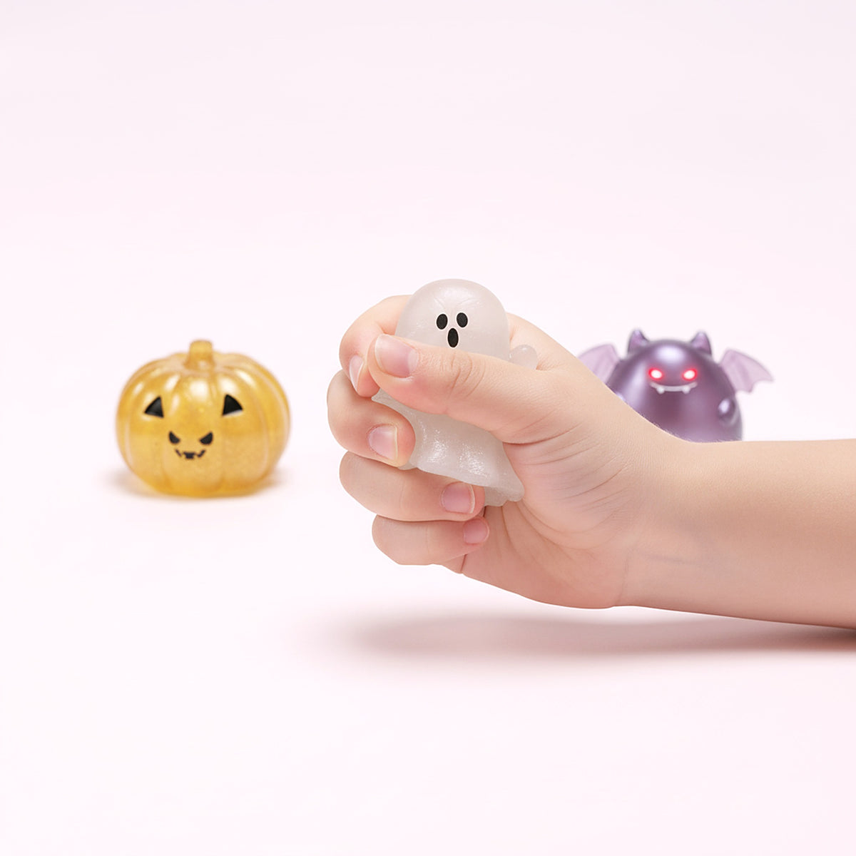 Squishy fantôme lumineux pressé dans une main d'enfant pour montrer sa taille